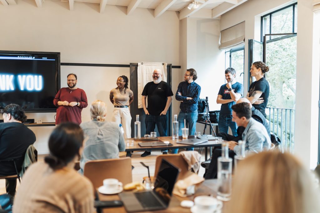 A diverse team gathers for an interactive presentation, promoting teamwork and collaboration.